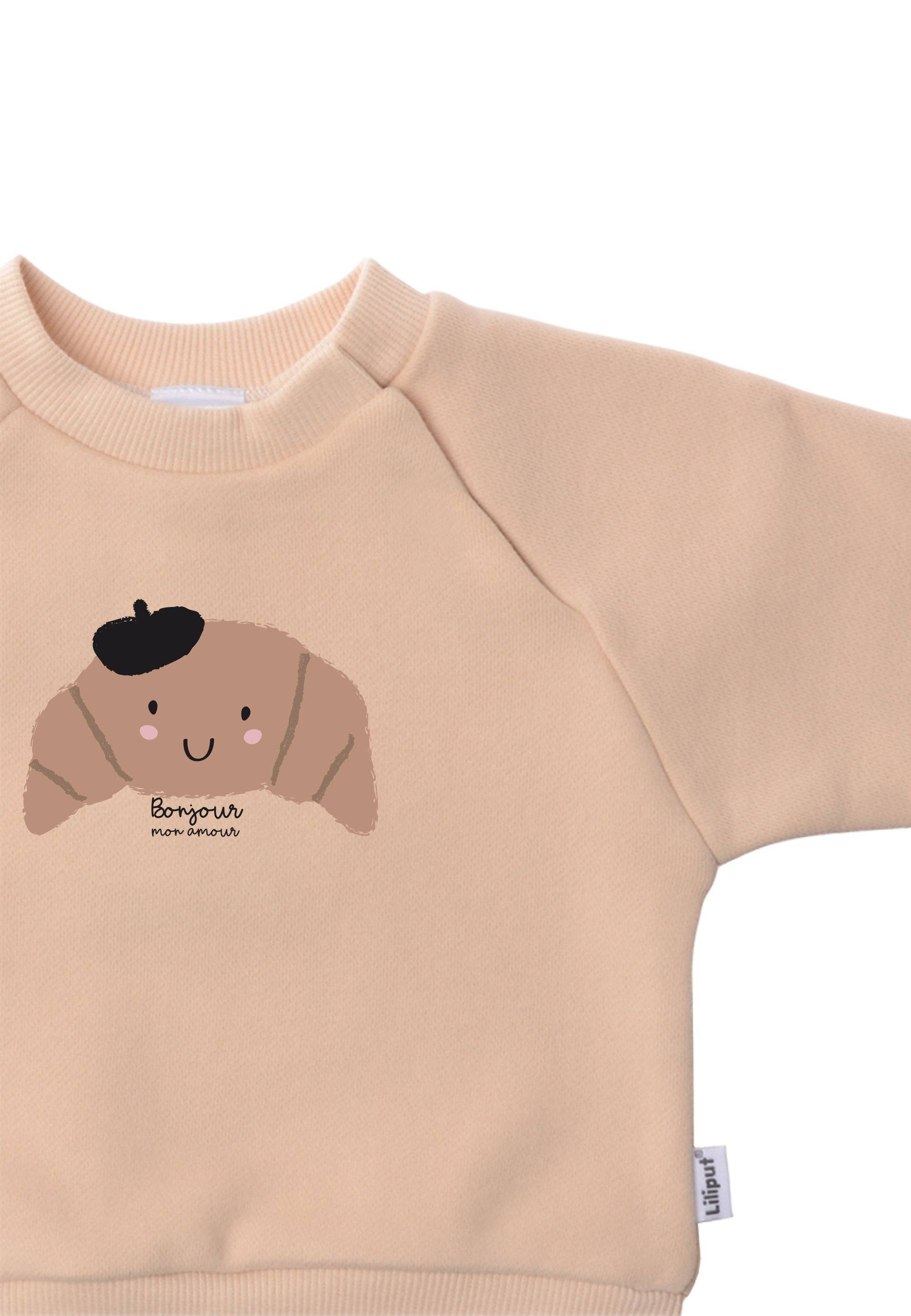 Kindertrui biologisch katoen in beige met speelse croissant opdruk